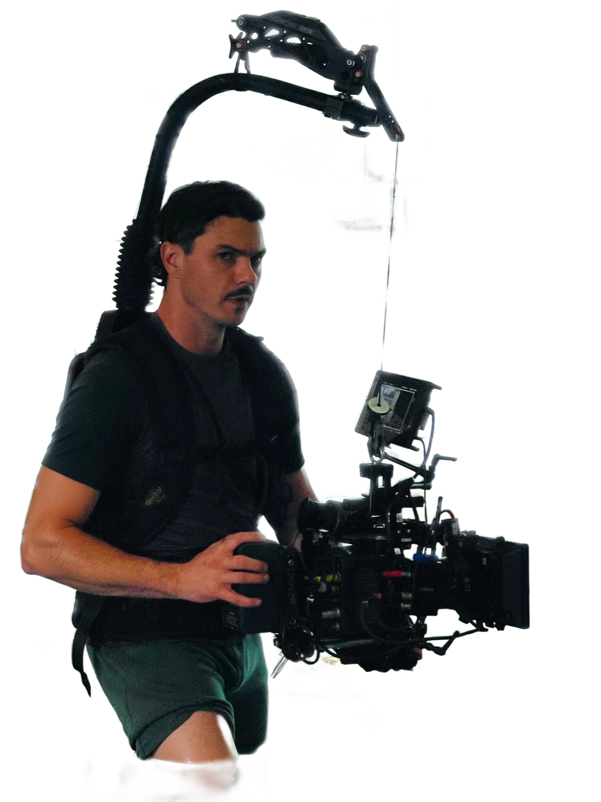 Ethan Schaeffer on set, easyrig over his shoulders, operating a cinema camera